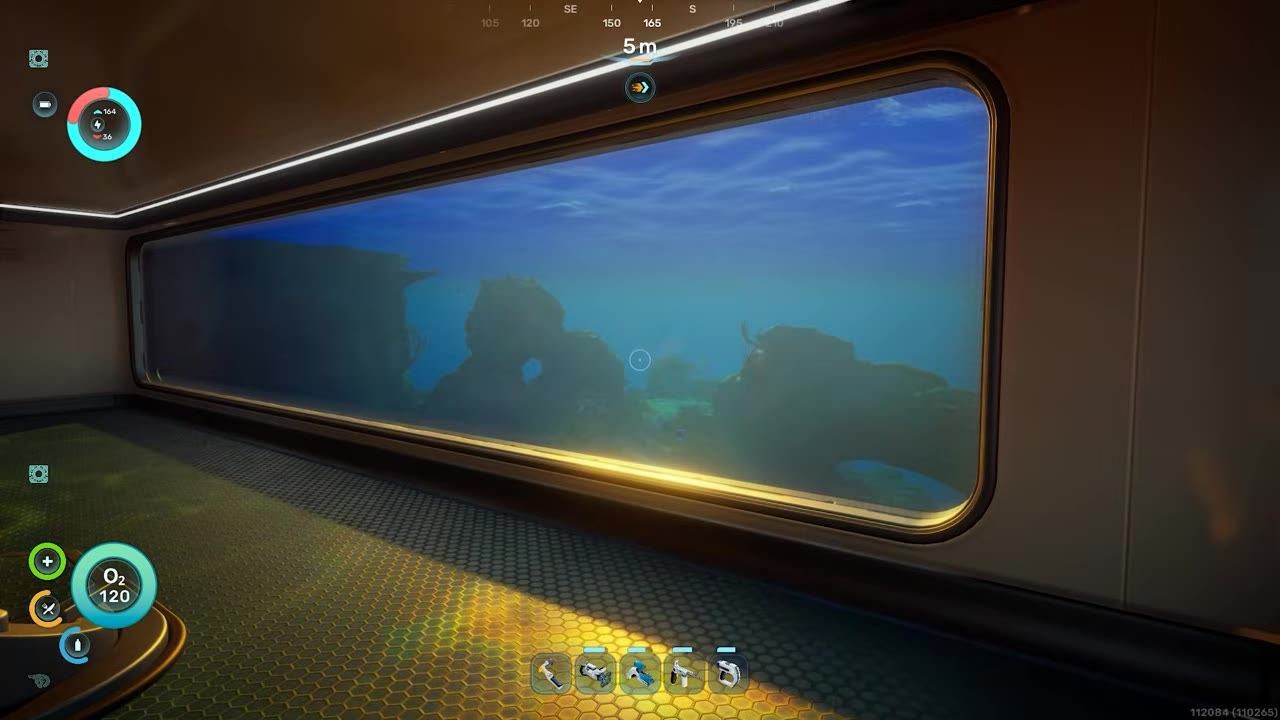 A view of a scenic underwater environment through a large window in a structure.