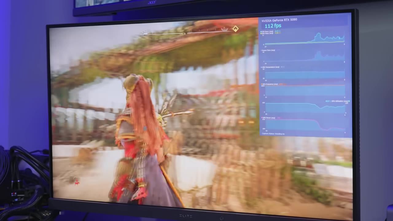 A game runs on a monitor with a performance overlay showing frame rate and GPU graphs on the right side.