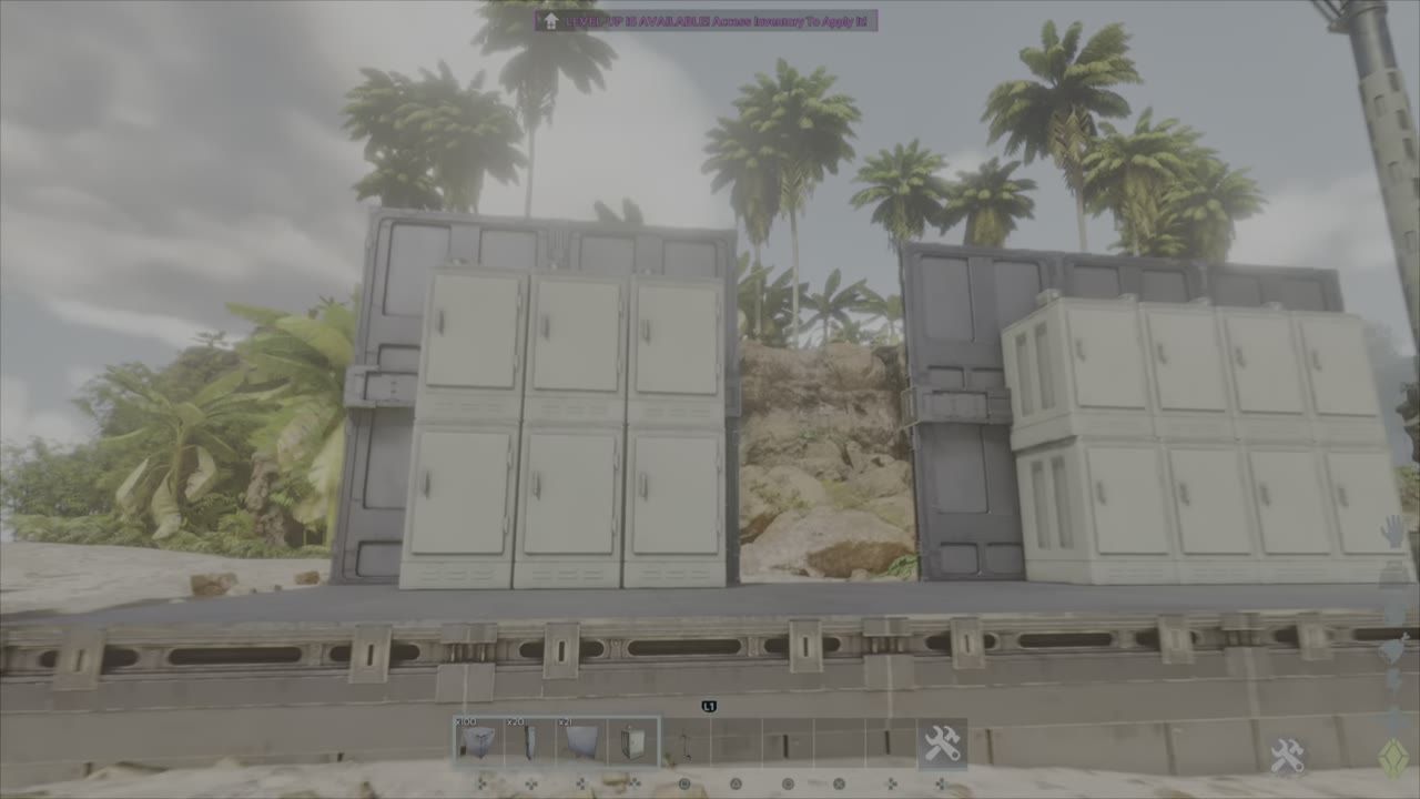 Two stacked fridge setups on beams with a tropical background.