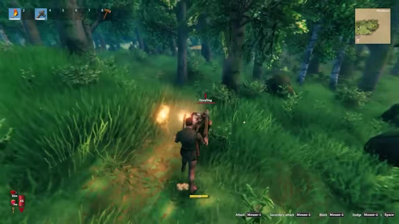 Game scene of a player holding a torch facing a creature labeled 'Greyling' in a forest environment.