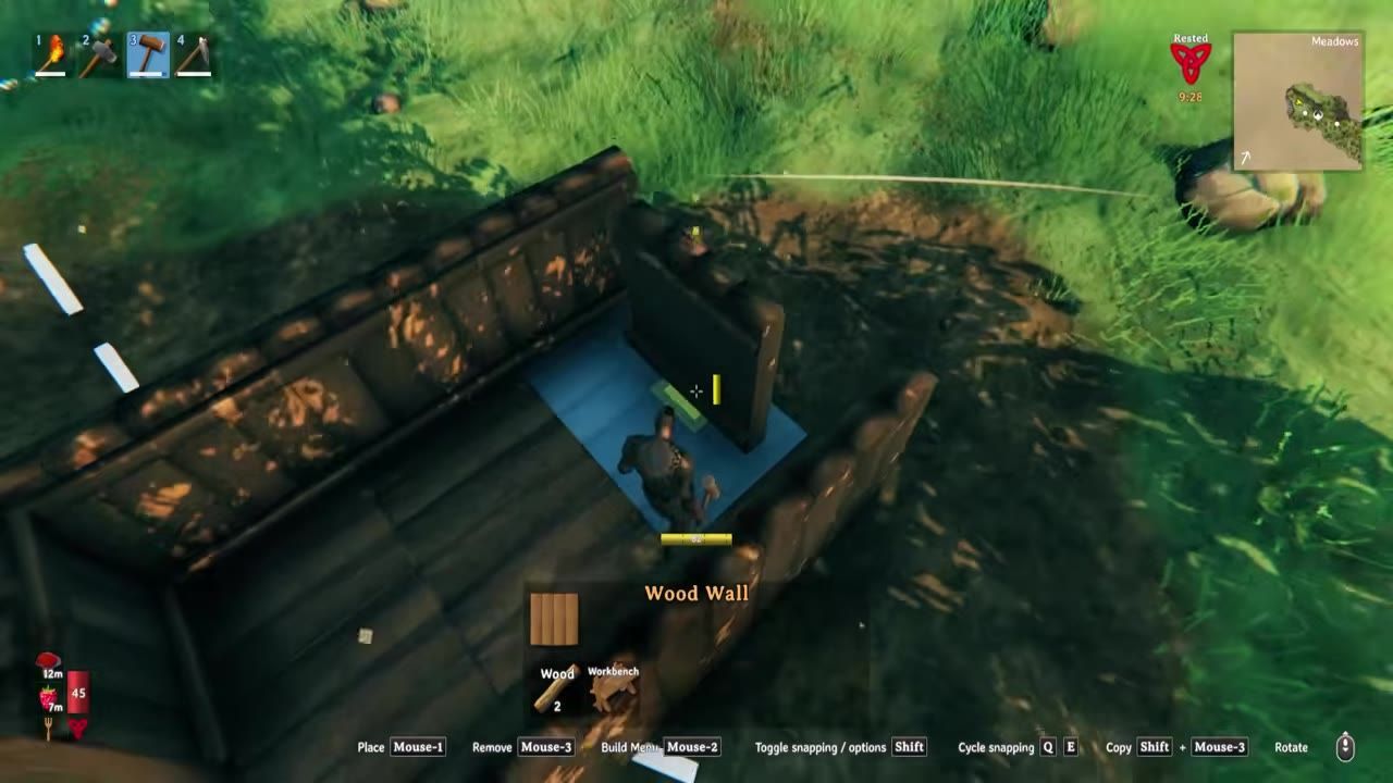 A game scene showing a player constructing wooden walls for a shelter.